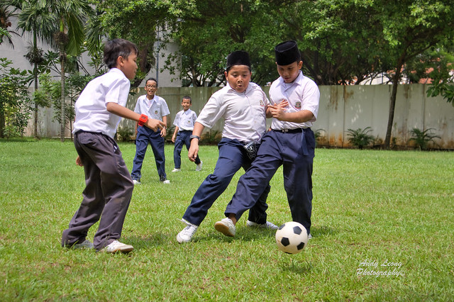 Children Playing Football At School